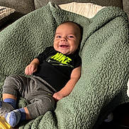 Giovanni joined the competition — help win amazing prizes! baby, smiling, blanket, couch, clothing, socks, person, infant, happy, indoor, portrait, relaxing, cozy, nike, cute, child, seated, soft, young, comfort