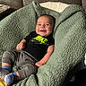 baby, smiling, blanket, couch, clothing, socks, person, infant, happy, indoor, portrait, relaxing, cozy, nike, cute, child, seated, soft, young, comfort