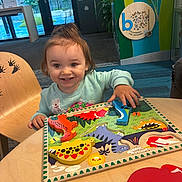 Stella joined the competition — help win amazing prizes! child, clothing, colorful, dinosaur, educational, face, furniture, game, hair, happy, indoor, learning, person, play, puzzle, smile, table, toddler, toy, wooden_chair