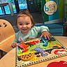child, clothing, colorful, dinosaur, educational, face, furniture, game, hair, happy, indoor, learning, person, play, puzzle, smile, table, toddler, toy, wooden_chair