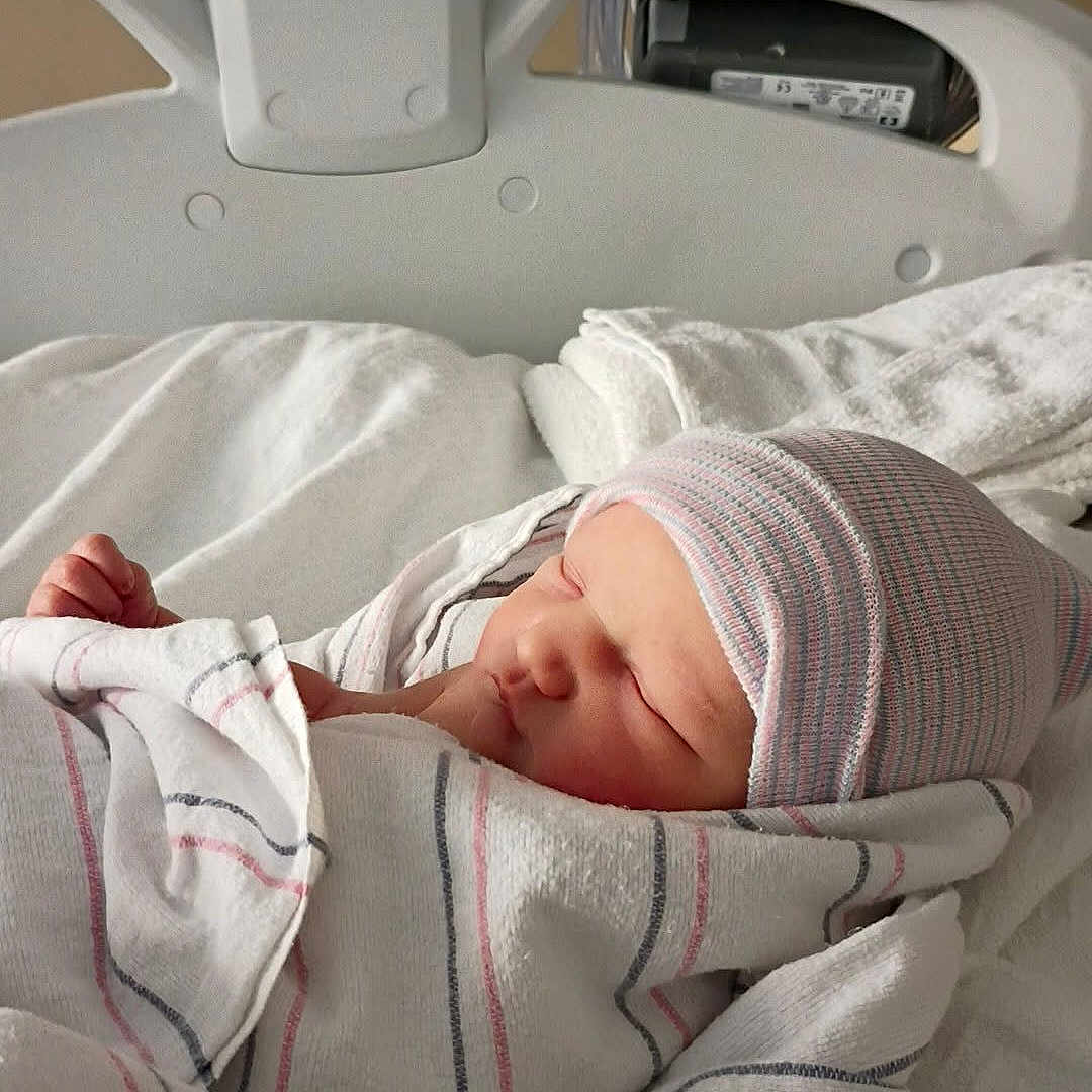 Serenity joined the competition — help win amazing prizes! newborn, baby, hospital, bed, blanket, cap, sleeping, infant, medical_equipment, white, soft, wrapped, portrait, peaceful, child, person, healthcare, cute, resting, indoors