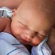 Serenity is registered to the contest to win money with this photo: newborn, baby, sleeping, infant, blanket, striped_blanket, swaddled, closeup, face, peaceful, resting, human, skin, arm, hospital, portrait, cute, child, soft_light, tender