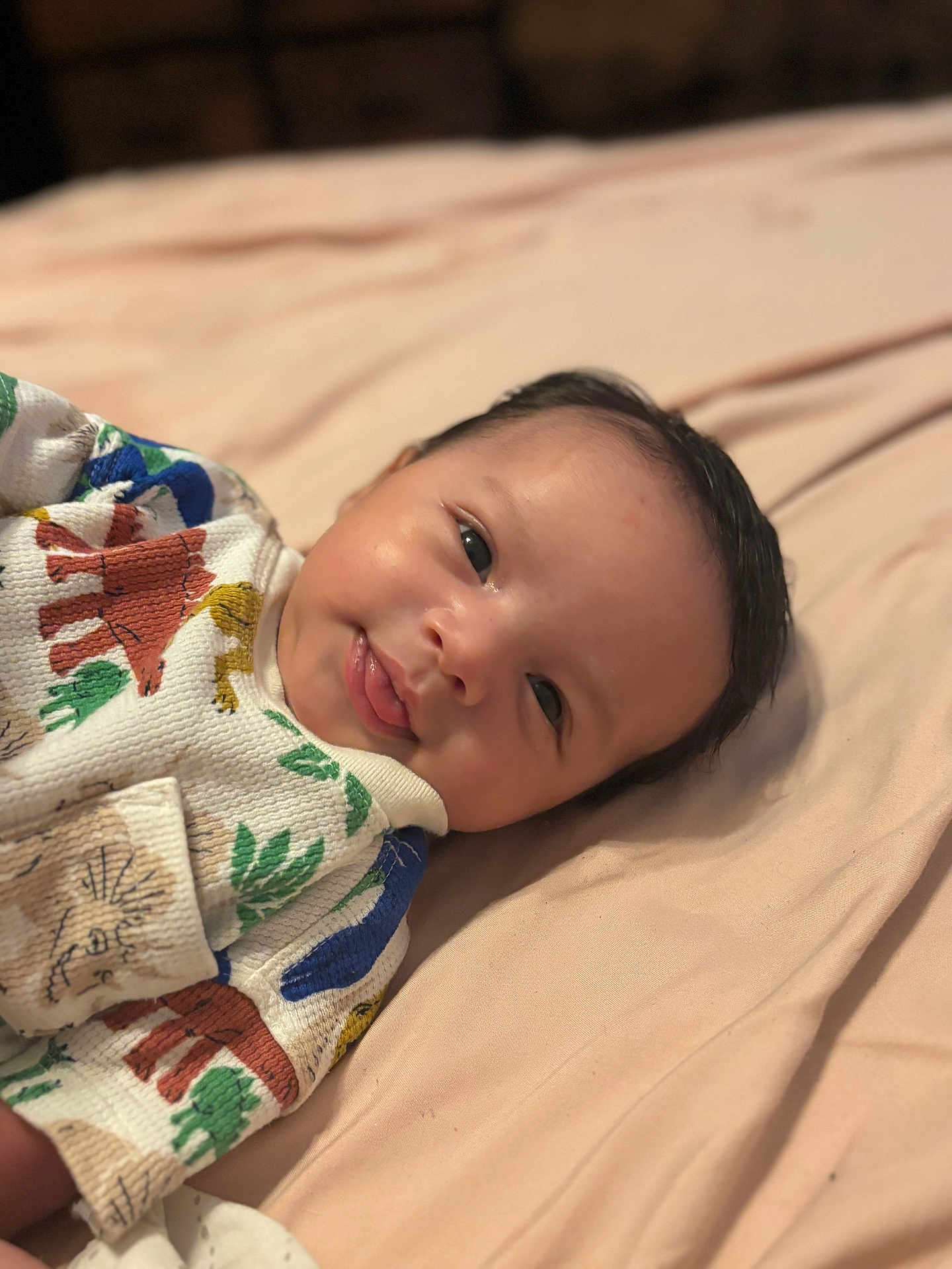 Makari joined the competition — help win amazing prizes! baby, infant, child, cute, smile, face, eyes, clothing, pattern, animal_print, blanket, lying_down, soft, skin, hair, portrait, indoors, young, expression, cozy