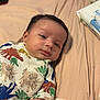 Makari is registered to the contest to win money with this photo: baby, infant, child, dinosaur_clothing, bed, bedding, blanket, face, portrait, skin, expression, cute, sleepy, lying_down, soft_fabric, indoors, person, young, casual, resting
