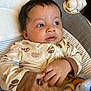 Makari joined the competition — help win amazing prizes! baby, infant, pajamas, face, hands, cushion, blanket, toy, sleepwear, baby_seat, indoor, child, cute, portrait, lying_down, soft_toy, cozy, expression, looking_away, skin