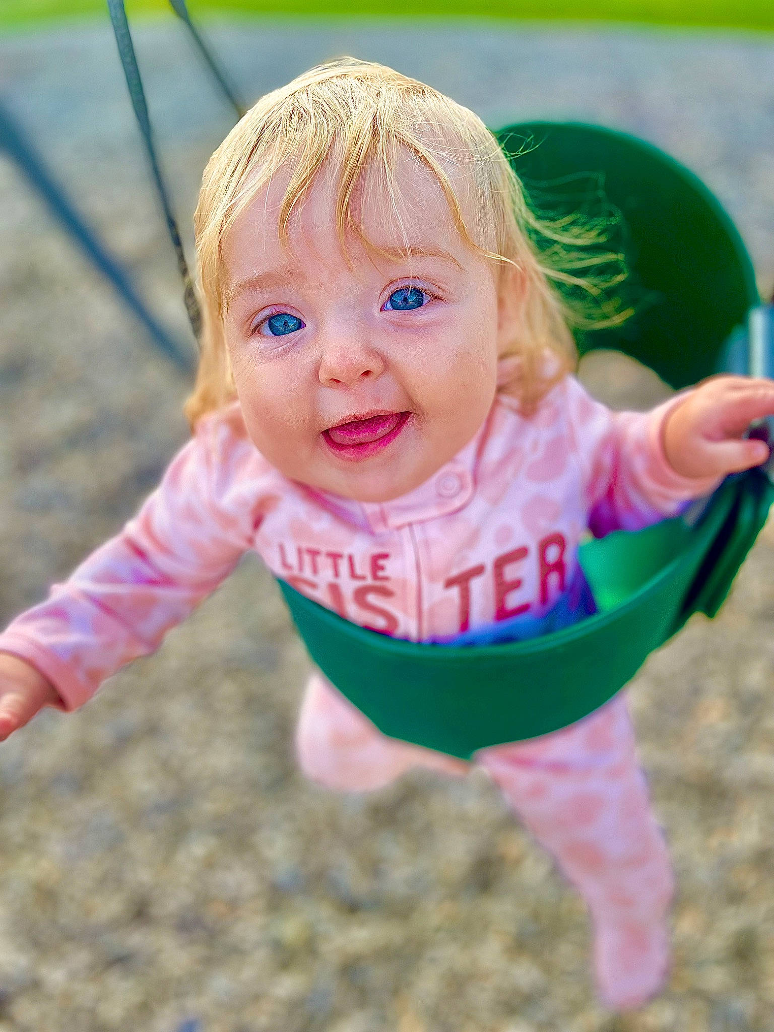 Oaklynne is registered to the contest to win money with this photo: baby, baby_toddler_clothing, bicycle_tire, eye, finger, fun, gesture, grass, hairstyle, happy, leisure, people_in_nature, person, pink, recreation, skin, sleeve, smile, swing, thumb