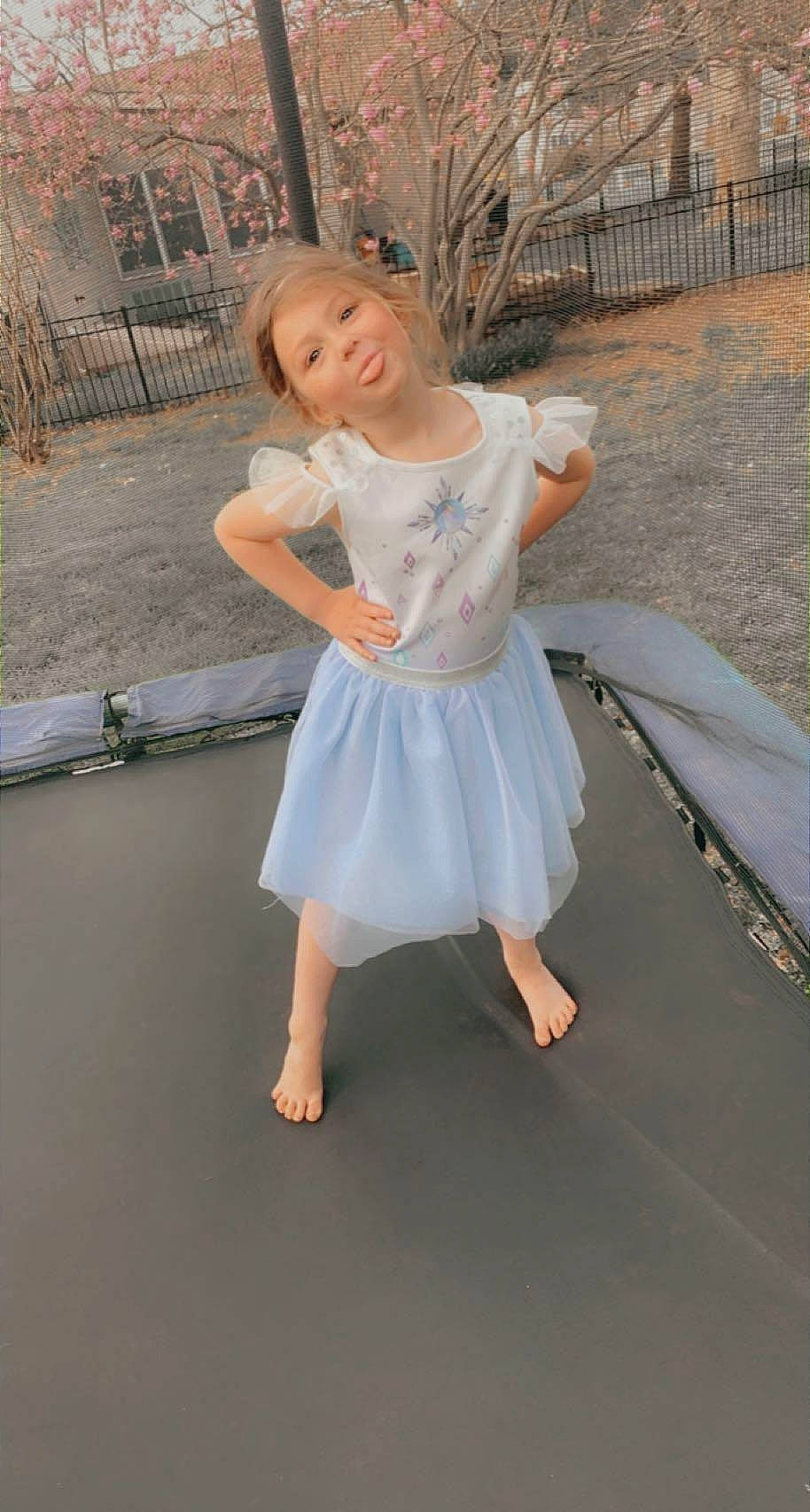 Hailee joined the competition — help win amazing prizes! barefoot, blond, child, dance, event, flash_photography, flooring, fun, grass, happy, human_leg, leisure, person, pink, recreation, sandal, shoulder, sitting, sleeve, smile