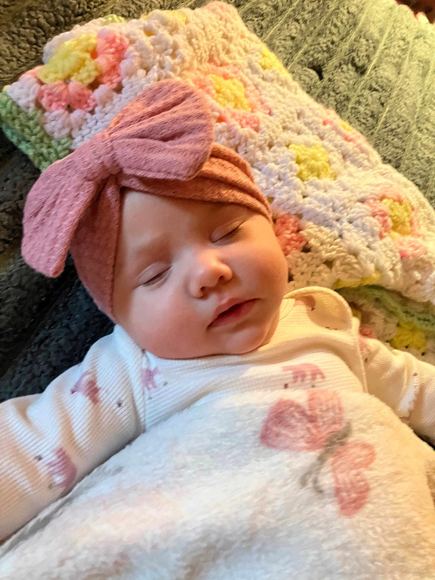 Zanica is registered to the contest to win money with this photo: baby, sleeping, blanket, headband, bow, crocheted_blanket, pink, white, yellow, green, face, infant, clothing, soft, cozy, closeup, rest, peaceful, child, indoors