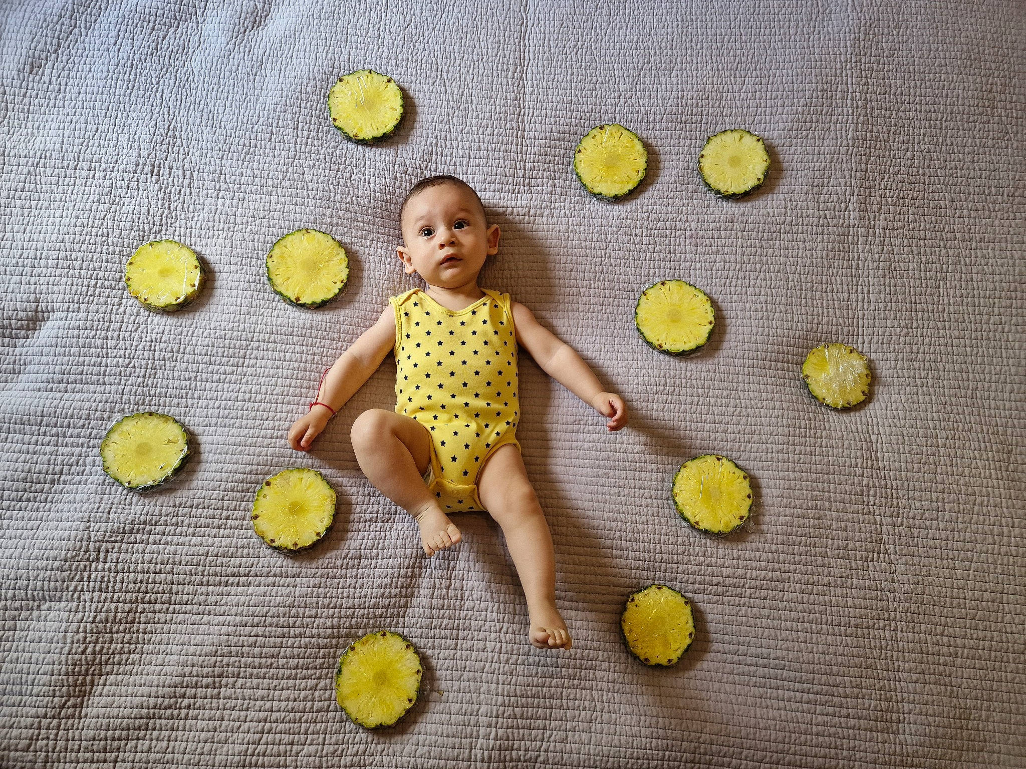 Damian is registered to the contest to win money with this photo: baby_toddler_clothing, baby_toys, ball, button, child, circle, facial_expression, fashion_accessory, font, happy, pattern, person, petal, sandal, sports_equipment, stuffed_toy, t_shirt, tennis_ball, textile, toy