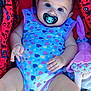 Almà a rejoint le concours — aidez-le/la à gagner de superbes lots ! baby, infant, pacifier, onesie, hearts_pattern, stroller, red_stroller, toy, blanket, child, cute, portrait, skin, hand, legs, clothing, face, expression, sitting, indoors