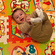 Nouaym a rejoint le concours — aidez-le/la à gagner de superbes lots ! baby, child, smiling, winnie_the_pooh, play_mat, toy, colorful, cartoon, floor_mat, infant, happy, sock, clothing, indoor, person, cute, playful, toddler, hand, foot