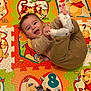 baby, child, smiling, winnie_the_pooh, play_mat, toy, colorful, cartoon, floor_mat, infant, happy, sock, clothing, indoor, person, cute, playful, toddler, hand, foot
