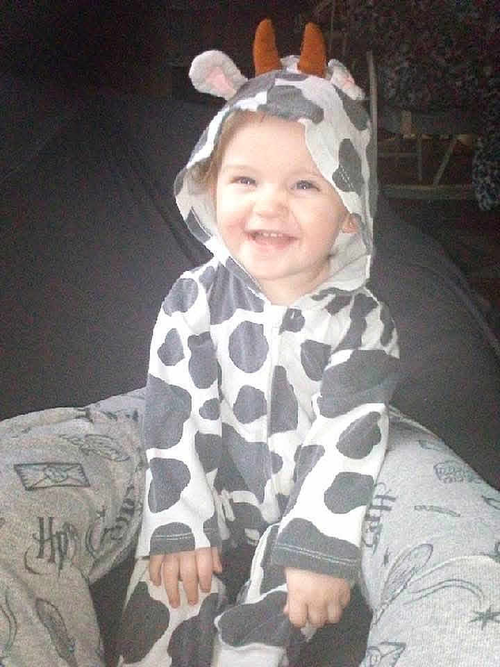 Kami joined the competition — help win amazing prizes! toddler, child, smiling, cow_costume, onesie, hood, ears, horns, happy, sitting, indoor, person, legs, clothing, cute, baby, cozy, fun, playful, joyful