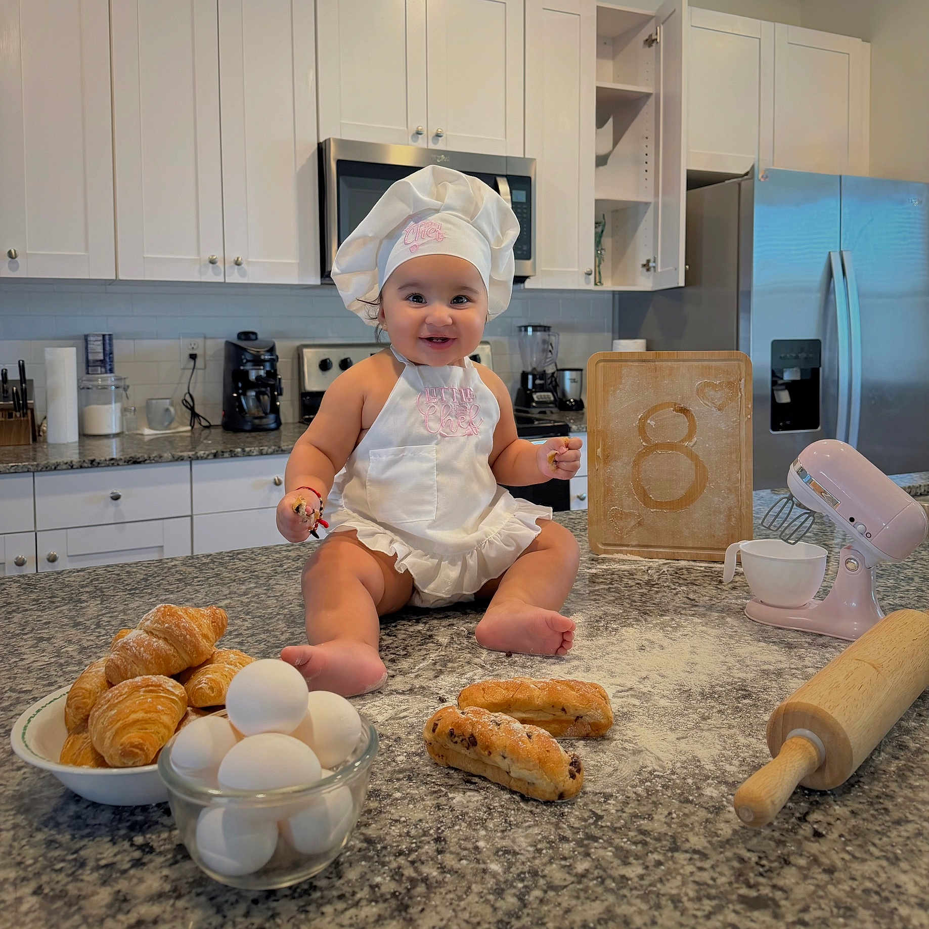 Madisson joined the competition — help win amazing prizes! apron, baby, baking, bread, chef_hat, cooking, countertop, croissants, cutting_board, eggs, flour, food, happy, home, infant, kitchen, mixer, portrait, rolling_pin, smile
