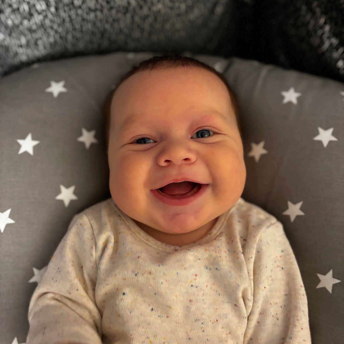 Jacob is registered to the contest to win money with this photo: baby, babylaughing, bodypart, cushion, face, finger, hand, happy, head, homedecor, laughing, newborn, pattern, person, photography, portrait, smile