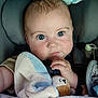 baby, blanket, blue_eyes, car_seat, child, closeup, clothing, comfort, cozy, cute, expression, face, hand, indoors, infant, looking, plush_toy, portrait, seatbelt, soft