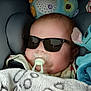 Jean-Pierre a rejoint le concours — aidez-le/la à gagner de superbes lots ! baby, blanket, car_seat, child, comfort, cozy, cute, head_support, indoors, infant, pacifier, plush_toy, portrait, relaxed, sleepy, soft_toy, stuffed_animal, sunglasses, wrapped, young_child