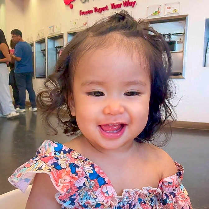 Crystal Hamamura is registered to the contest to win money with this photo: baby, background, bright, casual, child, curly_hair, cute, fashion, floral_dress, food_place, frozen_yogurt_shop, happy, indoor, modern, people, person, portrait, seat, smiling, toddler