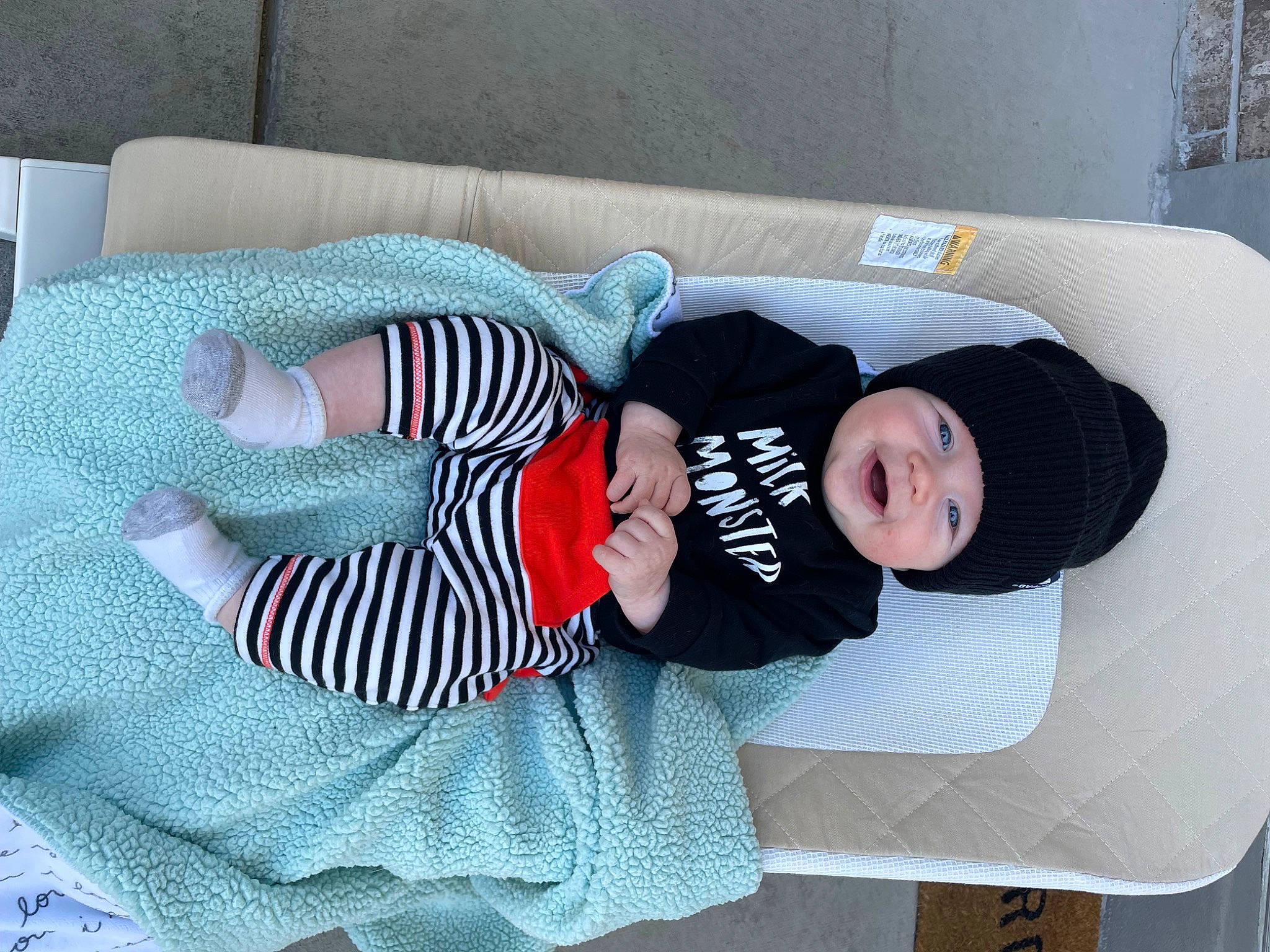 Jackson joined the competition — help win amazing prizes! baby, baby_products, baby_sleeping, baby_toddler_clothing, child, comfort, couch, hat, headwear, lap, linens, nap, pattern, person, room, sitting, sleeve, smile, sock, textile