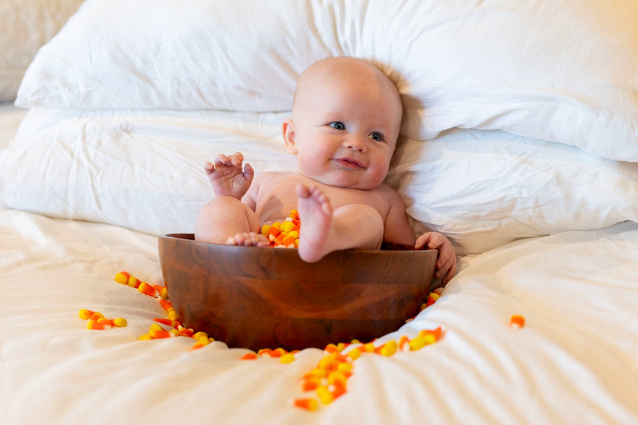 Jackson joined the competition — help win amazing prizes! arm, baby, baby_toddler_clothing, bed, bedding, child, comfort, couch, fun, happy, linens, orange, person, pillow, room, sitting, smile, sweetness, textile, throw_pillow