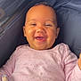 baby, smiling, infant, pink_sweater, plush_toy, stroller, child, happy, cute, portrait, clothing, face, head, person, seated, cozy, infant_clothing, baby_toy, young_child, comfort