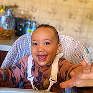 Noëlya participe au concours pour gagner de l'argent avec cette photo : baby, child, cute, expression, face, fleece_jacket, happy, high_chair, indoor, kitchen, person, portrait, reaching, safety_straps, seat, smiling, table, toddler, warm_clothing, young_child