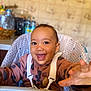 baby, child, cute, expression, face, fleece_jacket, happy, high_chair, indoor, kitchen, person, portrait, reaching, safety_straps, seat, smiling, table, toddler, warm_clothing, young_child