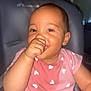 baby, child, thumb_sucking, pink_shirt, heart_pattern, cute, face, eyes, cushioned_chair, indoor, portrait, infant, person, young_child, happy, smiling, closeup, skin, clothing, seat
