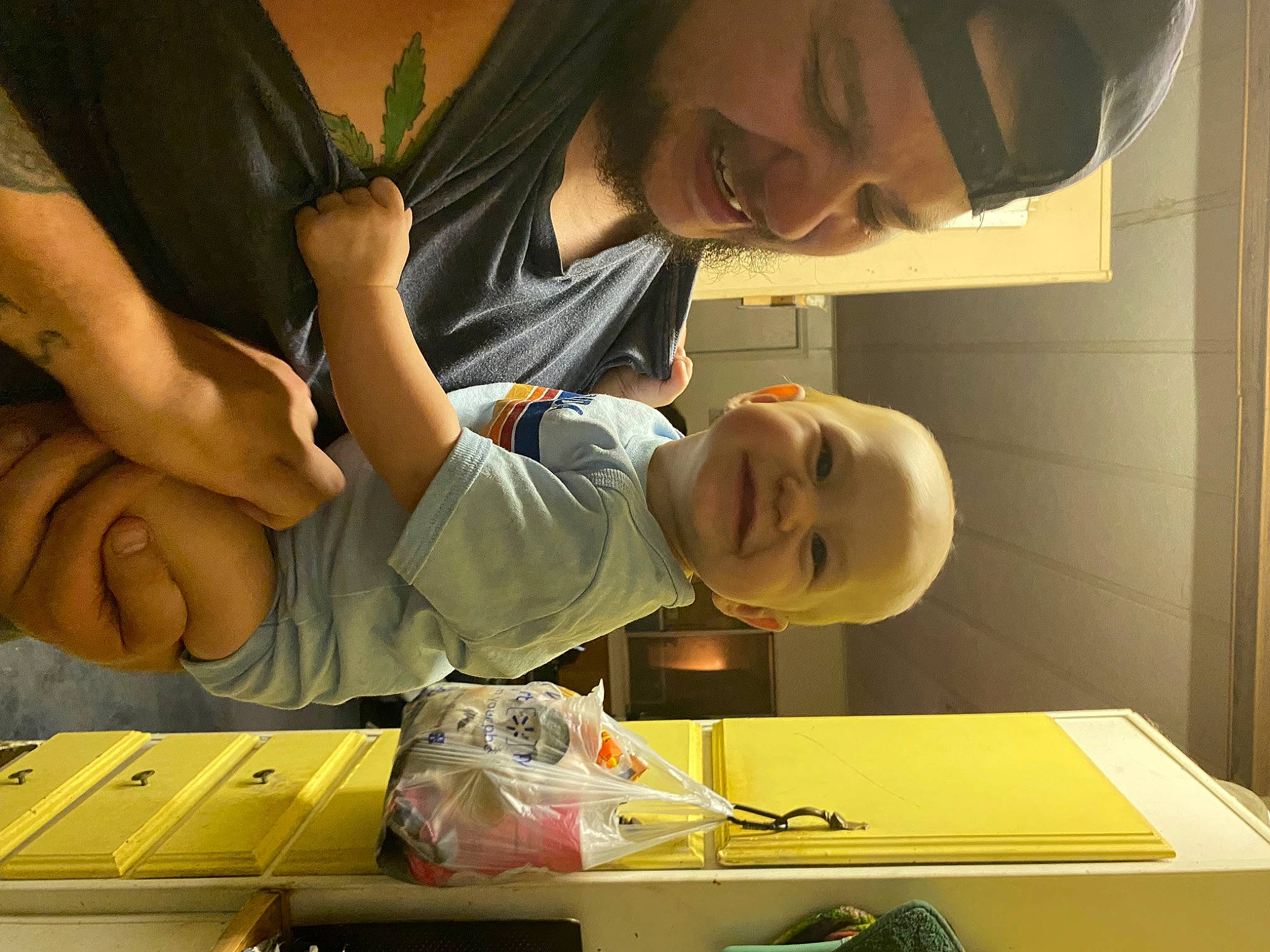 Everleigh is registered to the contest to win money with this photo: box, child, elbow, eyewear, fun, gesture, glasses, happy, homework, human_leg, joy, nail, person, play, room, sitting, smile, table, thumb, toddler