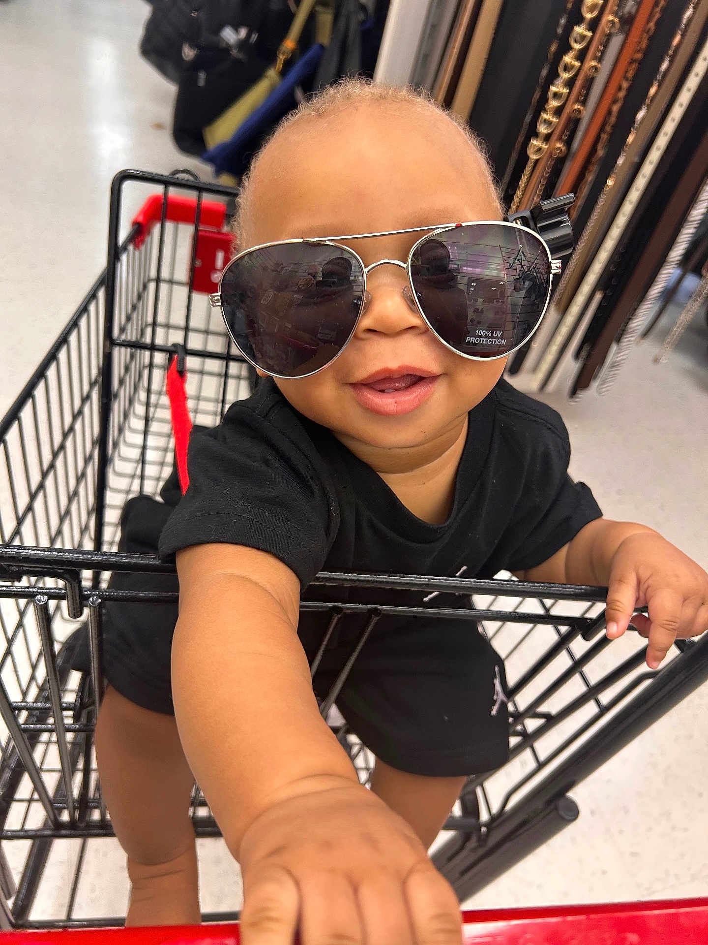 Kavarius joined the competition — help win amazing prizes! accessory, baby, belts, black_clothing, child, cute, face, fashion, hand, happy, head, indoor, mall, person, retail, shopping_cart, smiling, store, sunglasses, toddler