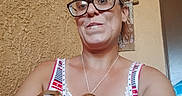 Goliath is registered to the contest to win money with this photo: brown_dog, casual, close_up, comfortable, dog, door, face, glasses, home_decor, indoor, looking_at_camera, necklace, pet, portrait, short_hair, sitting, smile, tank_top, wall, woman