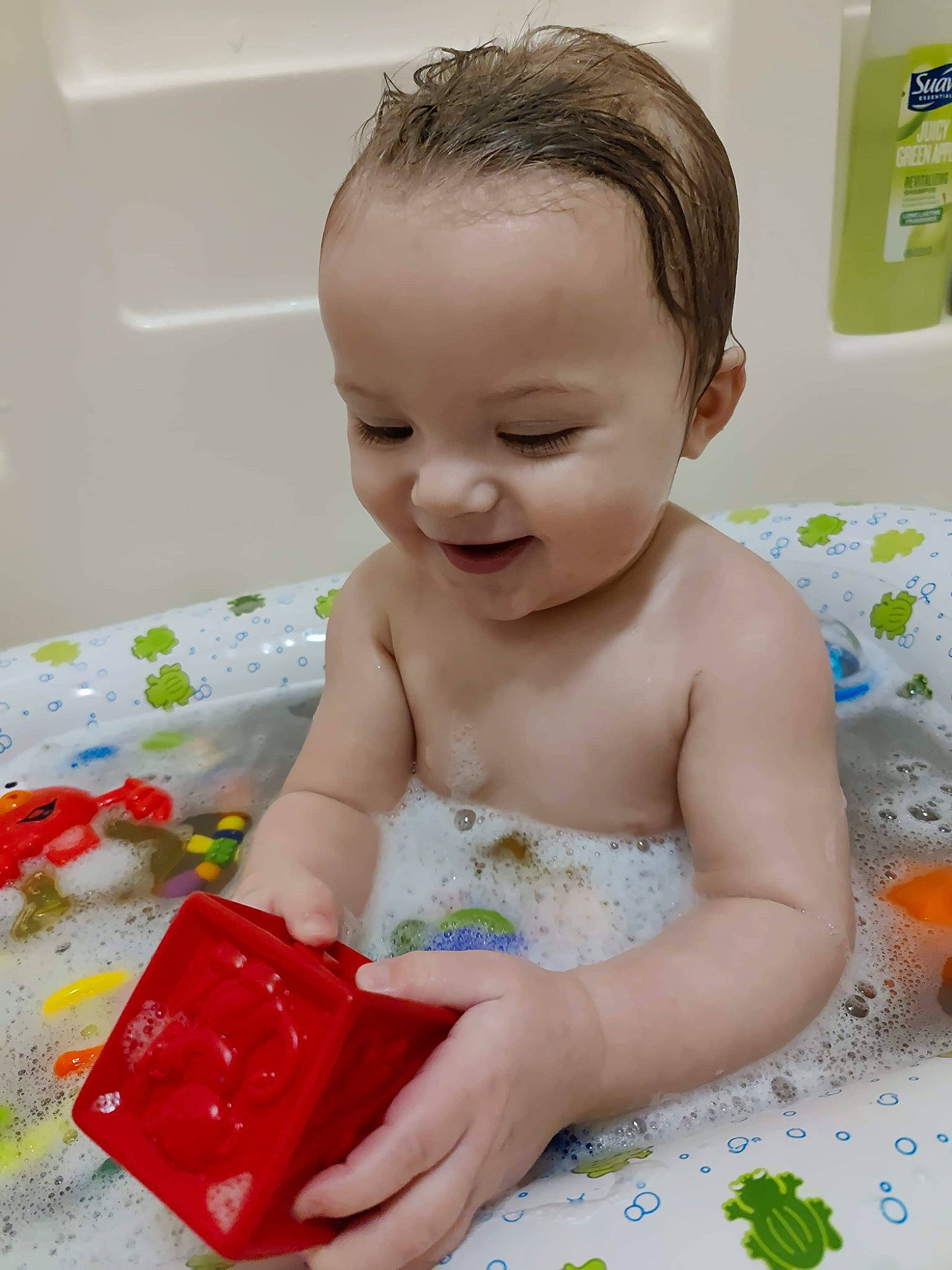 Jason is registered to the contest to win money with this photo: baby, baby_bathing, baby_playing_with_toys, baby_products, baby_toddler_clothing, bathing, bathroom, bathtub, child, facial_expression, fun, happy, person, photograph, play, plumbing, product, room, skin, smile