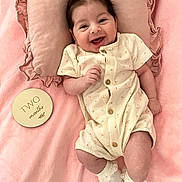Olivia Jade is registered to the contest to win money with this photo: baby, infant, smiling, pillow, blanket, pink, onesie, socks, cute, happy, lying_down, two_months, hair, child, soft_texture, portrait, indoors, newborn, adorable, ruffled