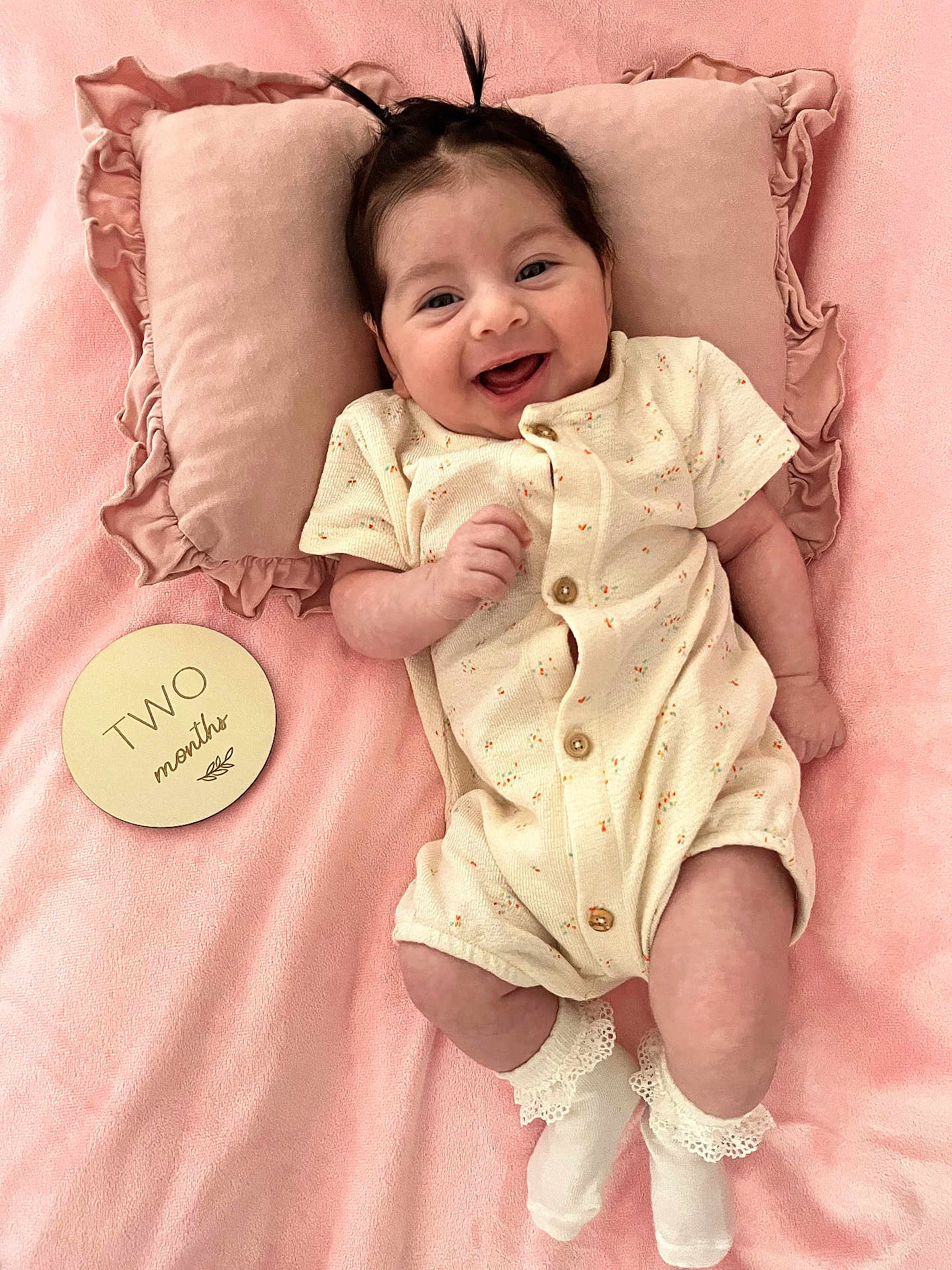 Olivia Jade is registered to the contest to win money with this photo: baby, infant, smiling, pillow, blanket, pink, onesie, socks, cute, happy, lying_down, two_months, hair, child, soft_texture, portrait, indoors, newborn, adorable, ruffled