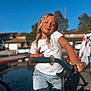 Penelope Rose is registered to the contest to win money with this photo: bicycle, bike_handlebars, blue_sky, casual_clothing, child, daytime, fun, jeans, outdoor, person, pose, recreation, smiling, street, suburban, summer, sunlight, wet_hair, white_tshirt, youth