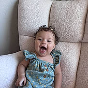 Arrow Saige joined the competition — help win amazing prizes! baby, child, curly_hair, blue_outfit, polka_dots, wooden_buttons, flower_clip, happy, smiling, sitting, chair, fluffy_chair, indoor, cute, person, young_child, portrait, comfortable, light_skin, joyful
