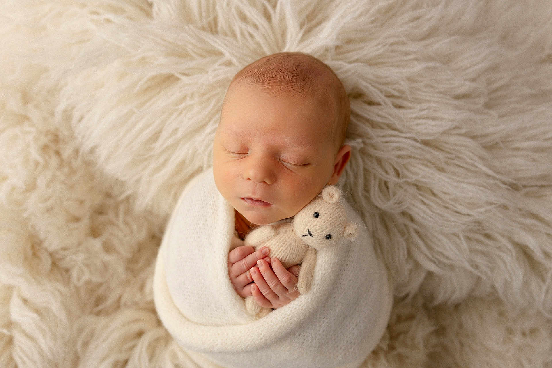 George is registered to the contest to win money with this photo: newborn, baby, infant, sleeping, wrapped, blanket, knitted_toy, teddy_bear, soft_texture, fur, cream_color, cute, peaceful, portrait, hands, face, cozy, resting, child, snuggled