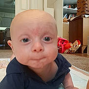 Jameson joined the competition — help win amazing prizes! baby, bags, blanket, books, bookshelf, carpet, child, dark_shirt, desk, eyes, face, home, indoor, infant, living_room, photography, portrait, sitting, toys, wide_eyed