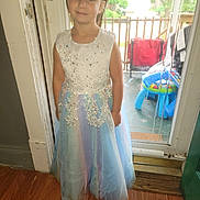 Destiny is registered to the contest to win money with this photo: casual, child, curtain, door, dress, floor, furniture, girl, glass, home, indoor, light, person, porch, portrait, smile, standing, toy, window, wood_floor