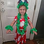 Destiny is registered to the contest to win money with this photo: barefoot, celebration, child, cute, door, dress, flower_crown, girl, green_leis, hands_out, headband, holiday, indoor, portrait, red_dress, smiling, standing, white_door, wood_floor, young_child