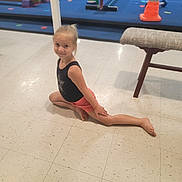 Destiny is registered to the contest to win money with this photo: balance, barefoot, child, equipment, exercise, flexibility, floor, girl, gym, gymnastics, indoor, leotard, orange_cone, pose, shorts, smile, split, sport, training, young