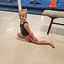 child, girl, gymnastics, split, floor, gym, exercise, flexibility, smile, young, sport, training, orange_cone, equipment, balance, indoor, pose, leotard, shorts, barefoot