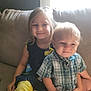 Preston joined the competition — help win amazing prizes! child, children, girl, boy, couch, sofa, indoor, smile, happy, sitting, plaid_shirt, yellow_pants, natural_light, window, family, portrait, casual_clothing, young, cute, toddler