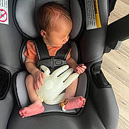 Nickolas joined the competition — help win amazing prizes! newborn, baby, car_seat, infant, sleeping, toy, inflated_glove, bandage, foot, gray, seat_belt, indoor, wood_floor, child, resting, small_hands, small_feet, head, clothing, safety