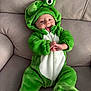 Nickolas is registered to the contest to win money with this photo: baby, child, clothing, couch, cute, face, frog_costume, green_costume, hands, happy, hood, indoor, infant, person, playful, plush, seated, smile, soft_texture, zipper
