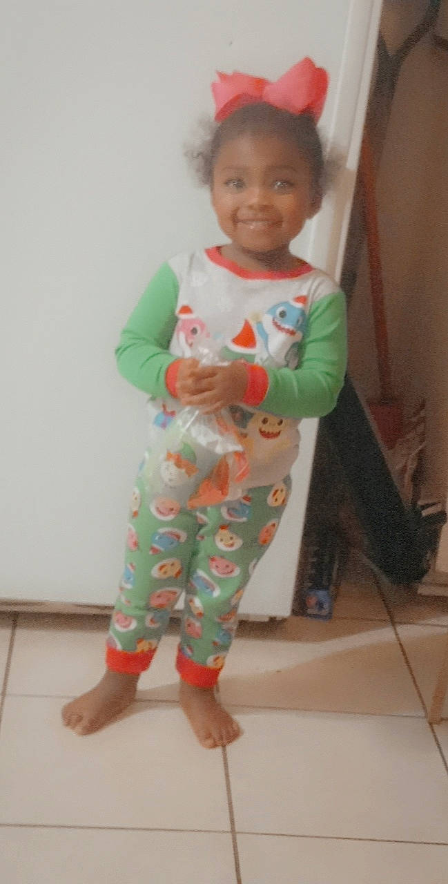 Cali joined the competition — help win amazing prizes! baby, baby_toddler_clothing, child, clothing, face, floor, flooring, foot, gesture, hand, head, human_body, joy, outerwear, person, skin, sleeve, smile, standing, t_shirt