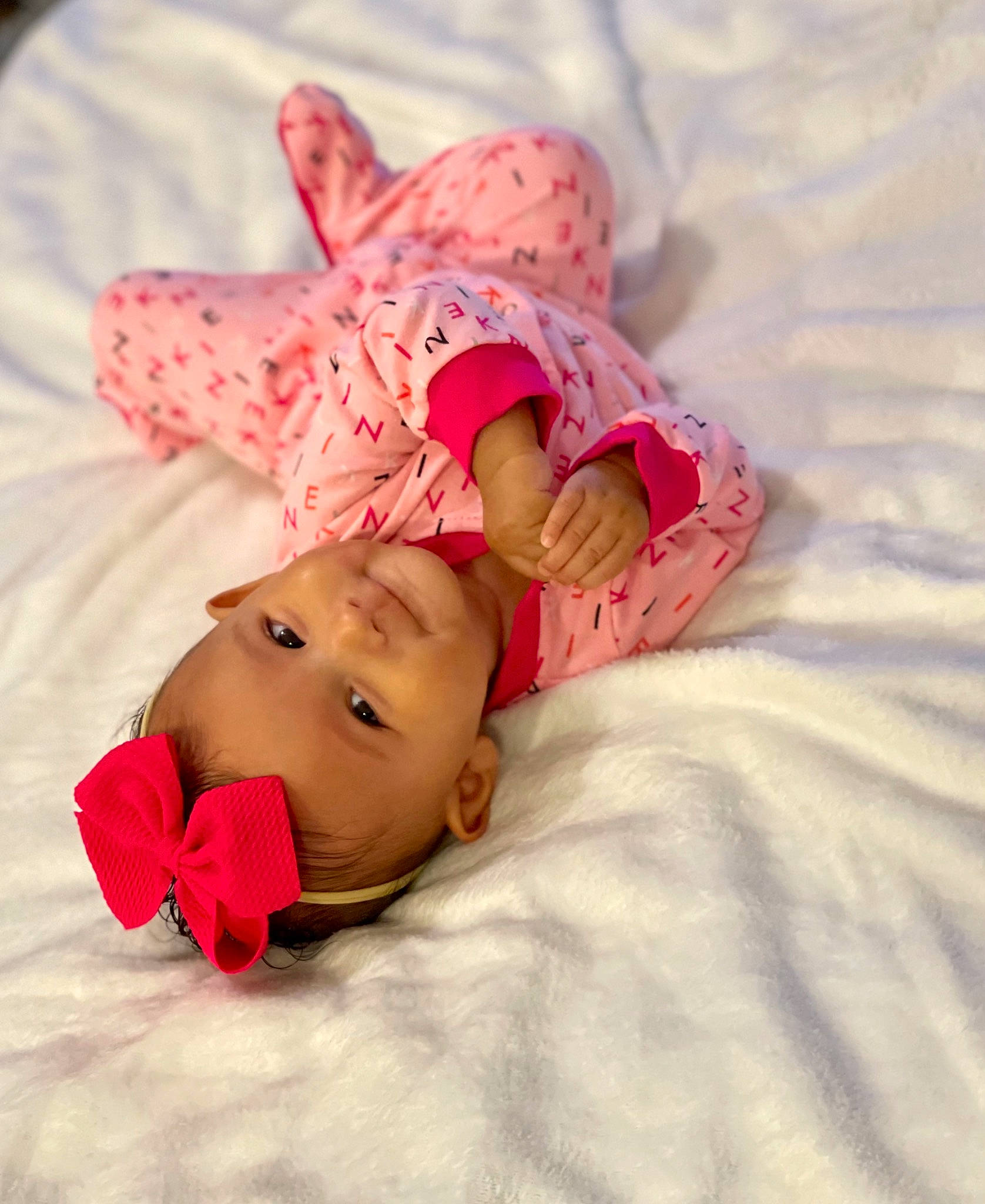 Amelia joined the competition — help win amazing prizes! arm, baby, baby_products, baby_sleeping, baby_toddler_clothing, bed, bedding, bedtime, child, comfort, finger, happy, human_body, linens, magenta, person, pink, sitting, skin, sleeve