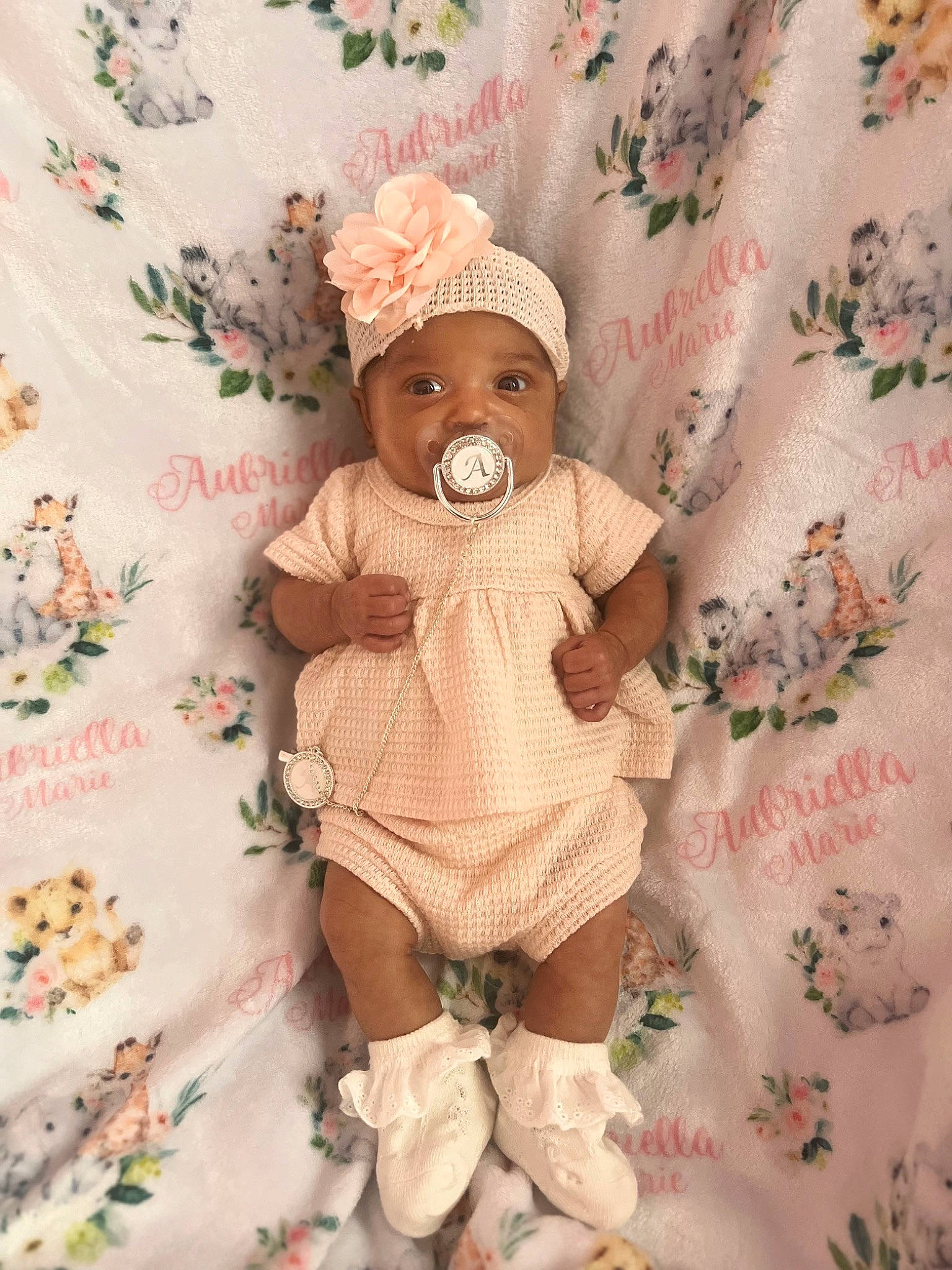 Aubriella joined the competition — help win amazing prizes! arm, baby, baby_products, baby_sleeping, baby_toddler_clothing, child, comfort, fashion_accessory, headgear, headwear, human_leg, linens, pattern, peach, person, pink, room, sleeve, sock, stuffed_toy