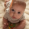 baby, infant, toy, rattle, blanket, soft, cute, child, portrait, lying_down, curious, closeup, indoor, skin, head, eyes, hand, clothing, striped_shirt, play