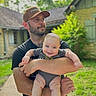 Will joined the competition — help win amazing prizes! man, baby, smile, holding, cap, beard, outdoor, house, greenery, grass, sidewalk, person, happy, child, casual_clothing, daylight, nature, family, portrait, toddler